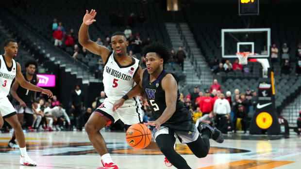 Nov 19, 2023; Las Vegas, NV, USA; Washington Huskies guard Sahvir Wheeler (5) dribbles against San Diego State Aztecs guard Lamont Butler (5) during an overtime period at T-Mobile Arena. Mandatory Credit: Stephen R. Sylvanie-USA TODAY Sports